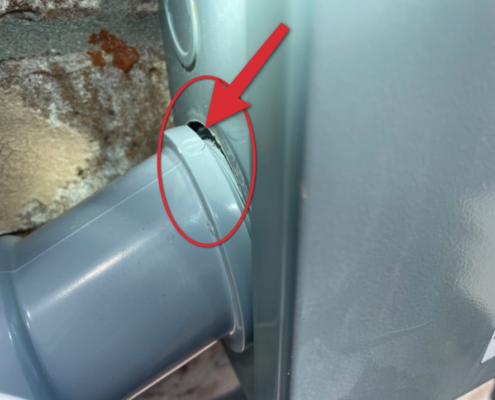 Open gap in main electrical panel exposing internal components